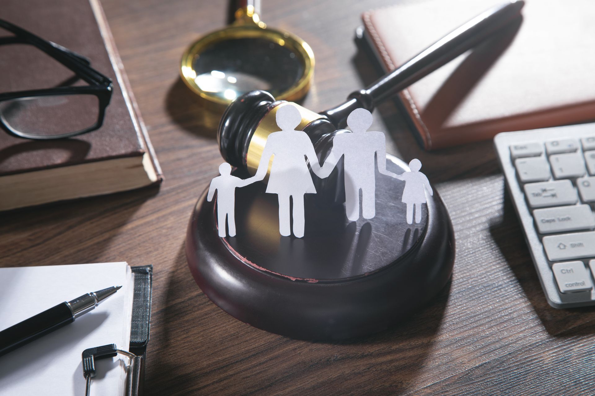 Paper cut family, judge gavel, book and other objects. Paper cut family, judge gavel, book and other objects.