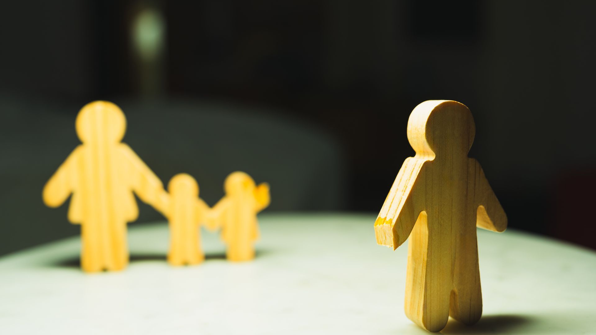 Broken family symbol separating father from mother and children. A concept for a divorce lawyer. Broken family symbol separating father from mother and children. A concept for a divorce lawyer.