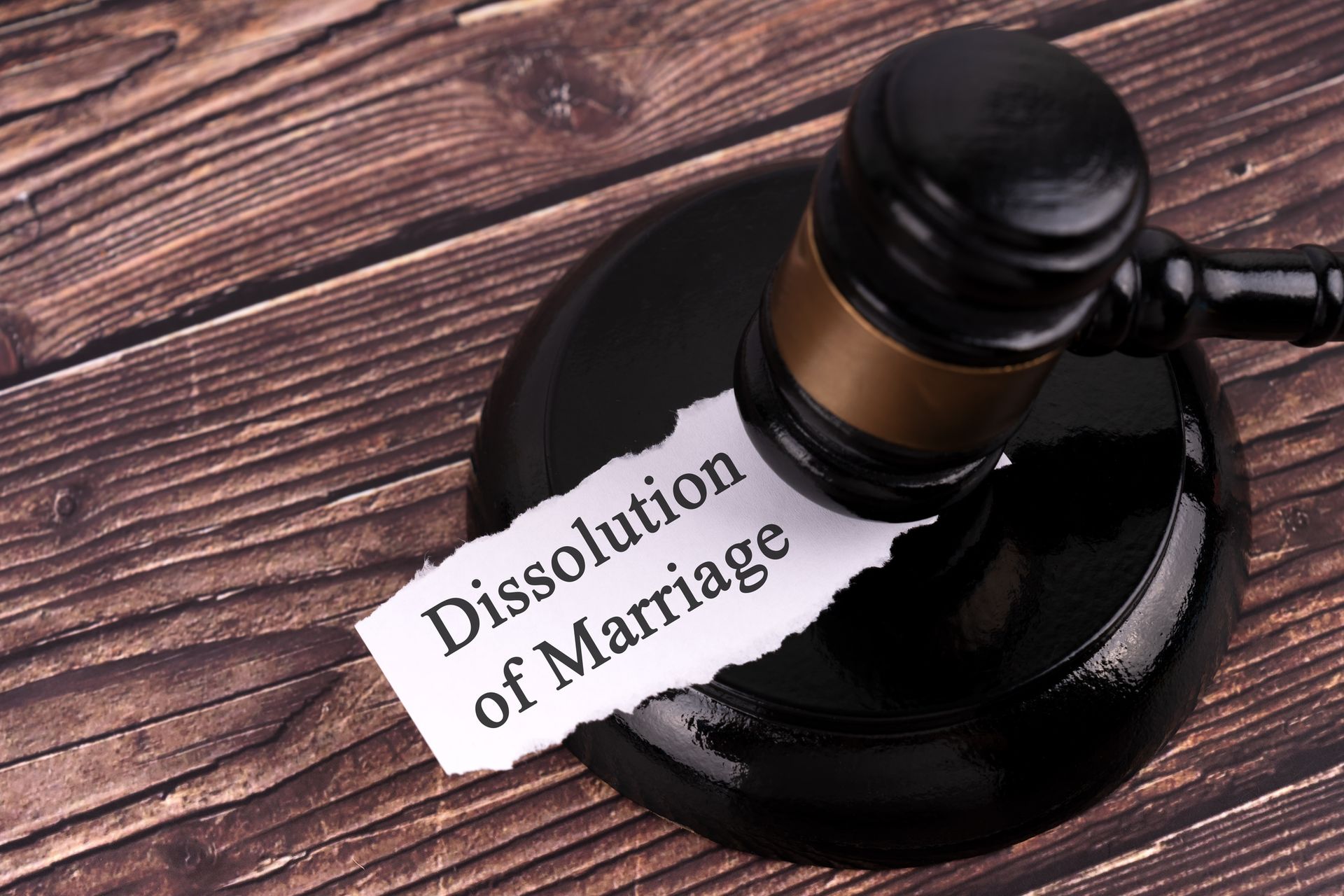 Dissolution of marriage paper with a gavel on top.