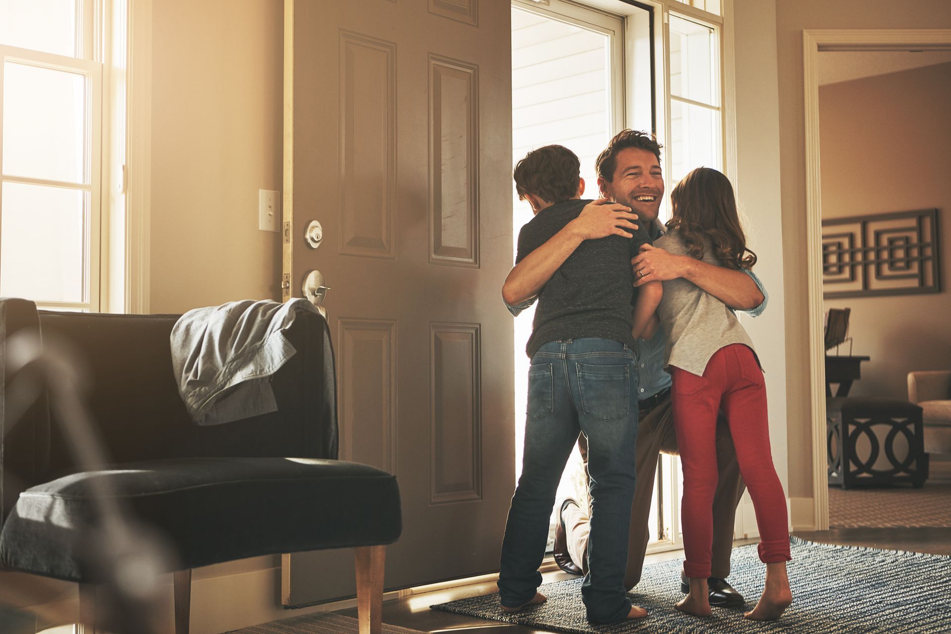 A father being welcomed by his two children after visiting a local divorce lawyer.