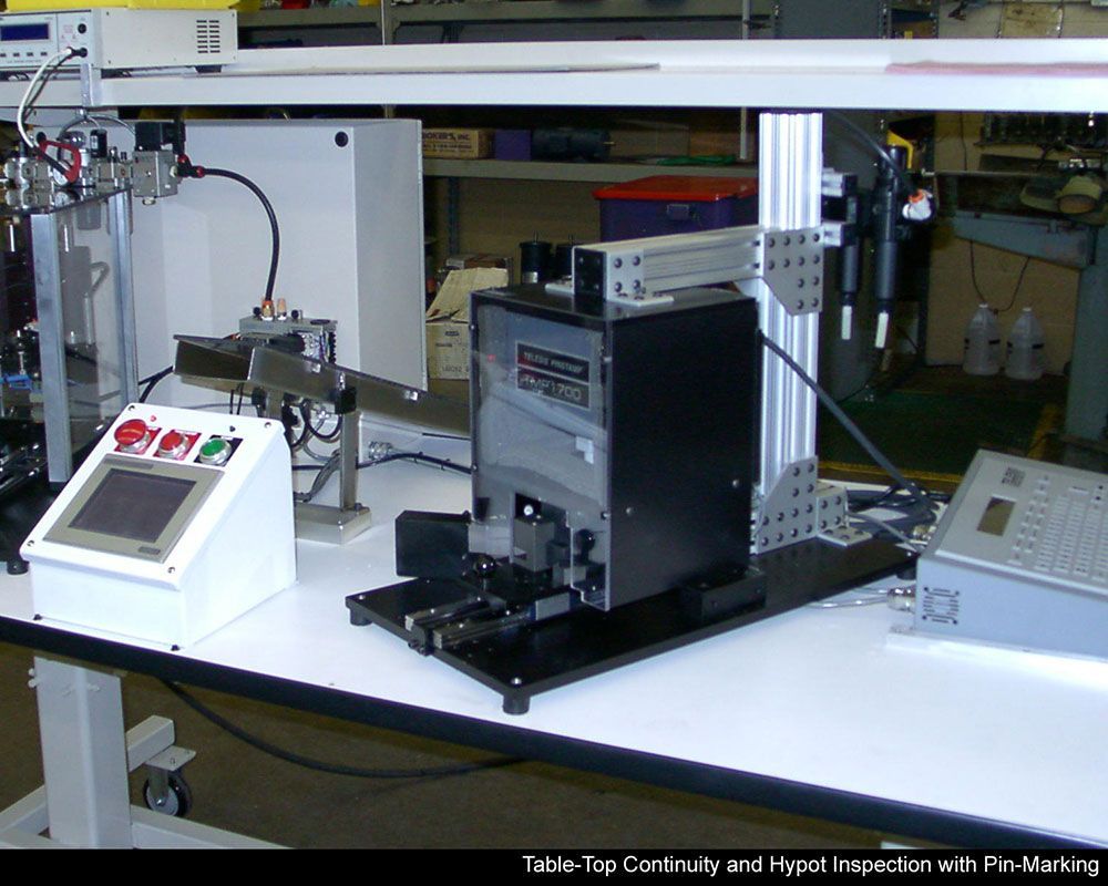A machine on a table that says table top continuity and hypol inspection with pe-marking