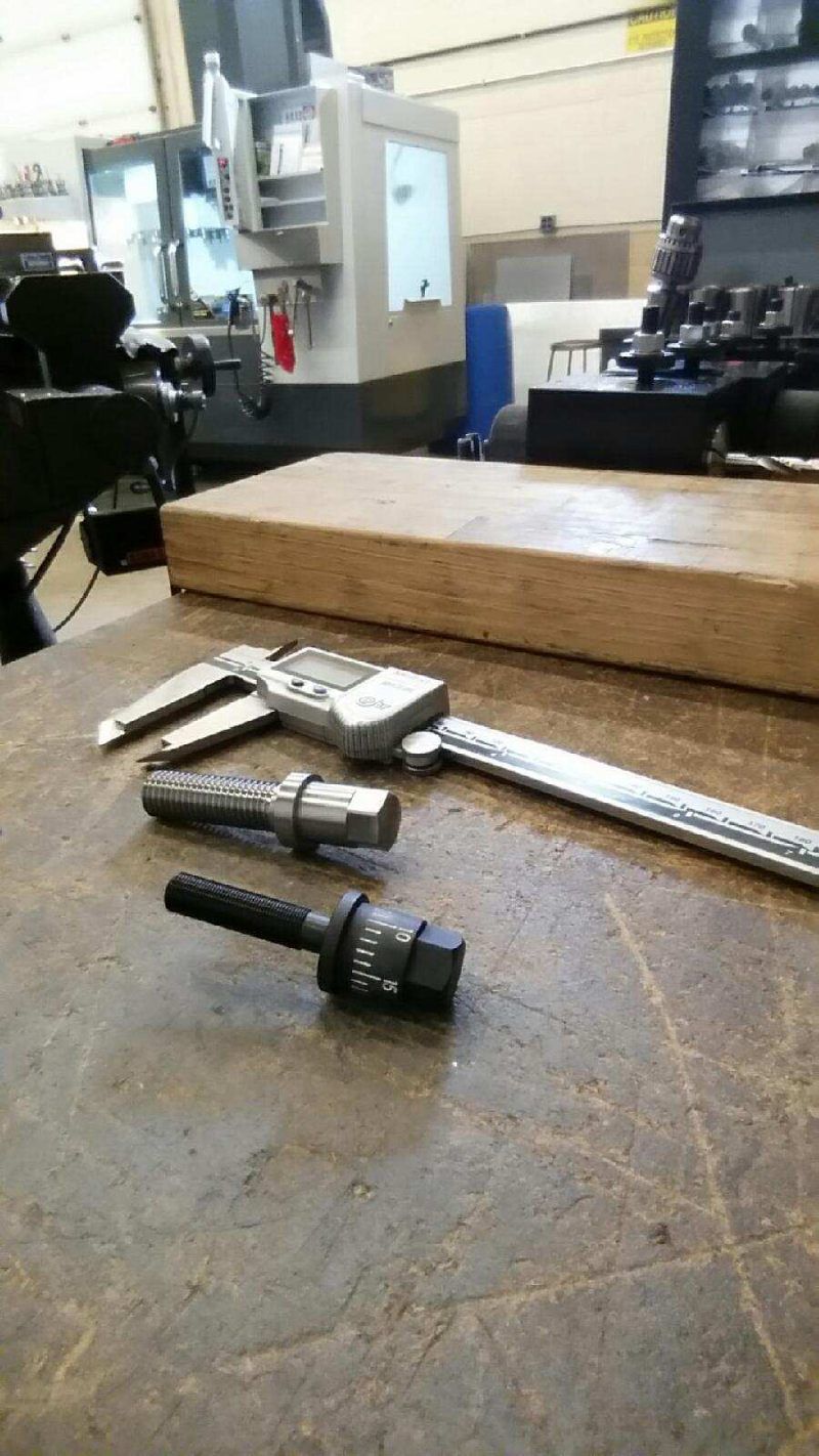 A pair of calipers sitting on top of a wooden table.