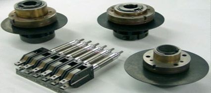 A group of metal parts are sitting on top of each other on a table.