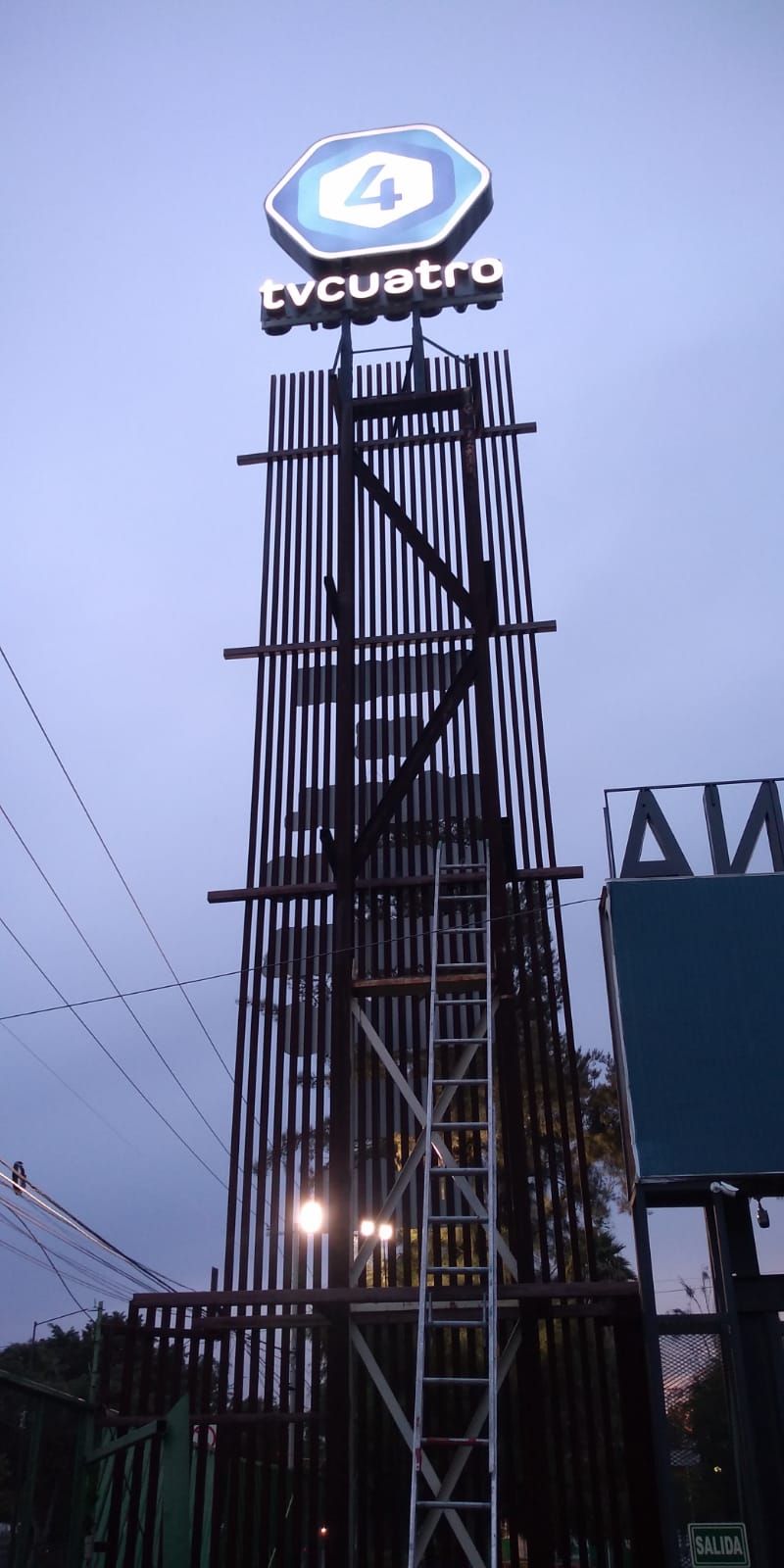 Un edificio muy alto con un cartel en la parte superior que dice quatro