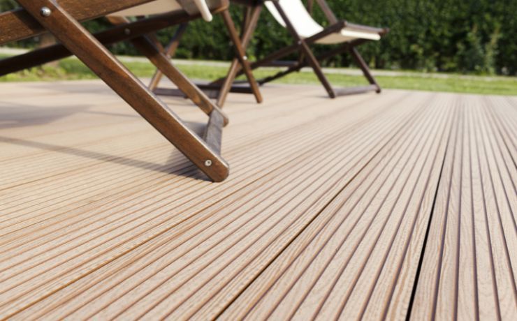 A photo of a composite deck in the backyard of a home in San Bernardino, California. The deck is made out of composite materials and has two chairs sitting on it.