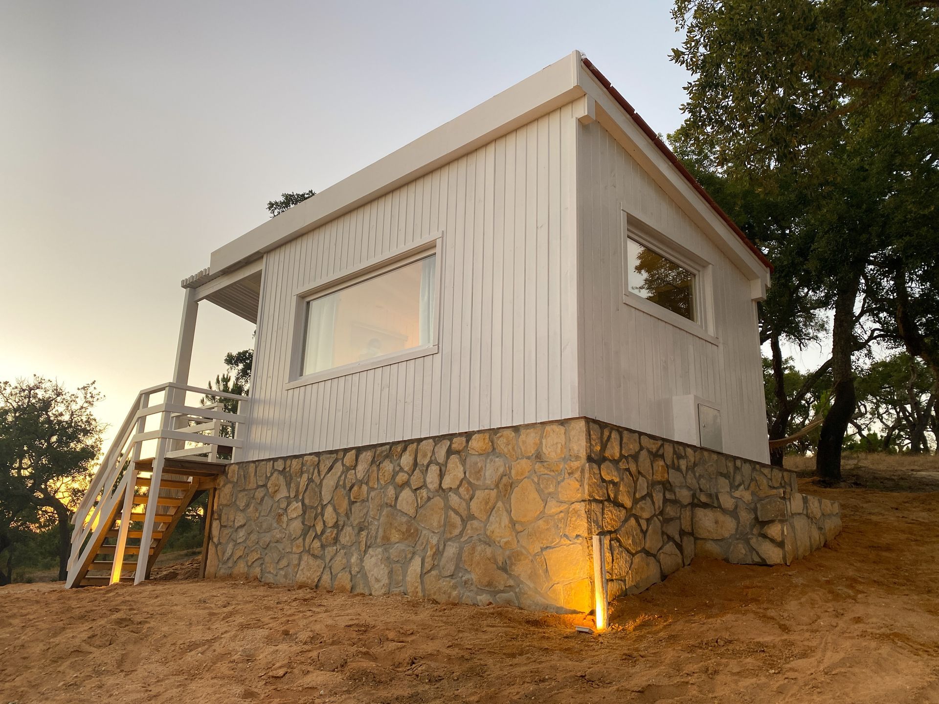 A small white house with stairs leading up to it