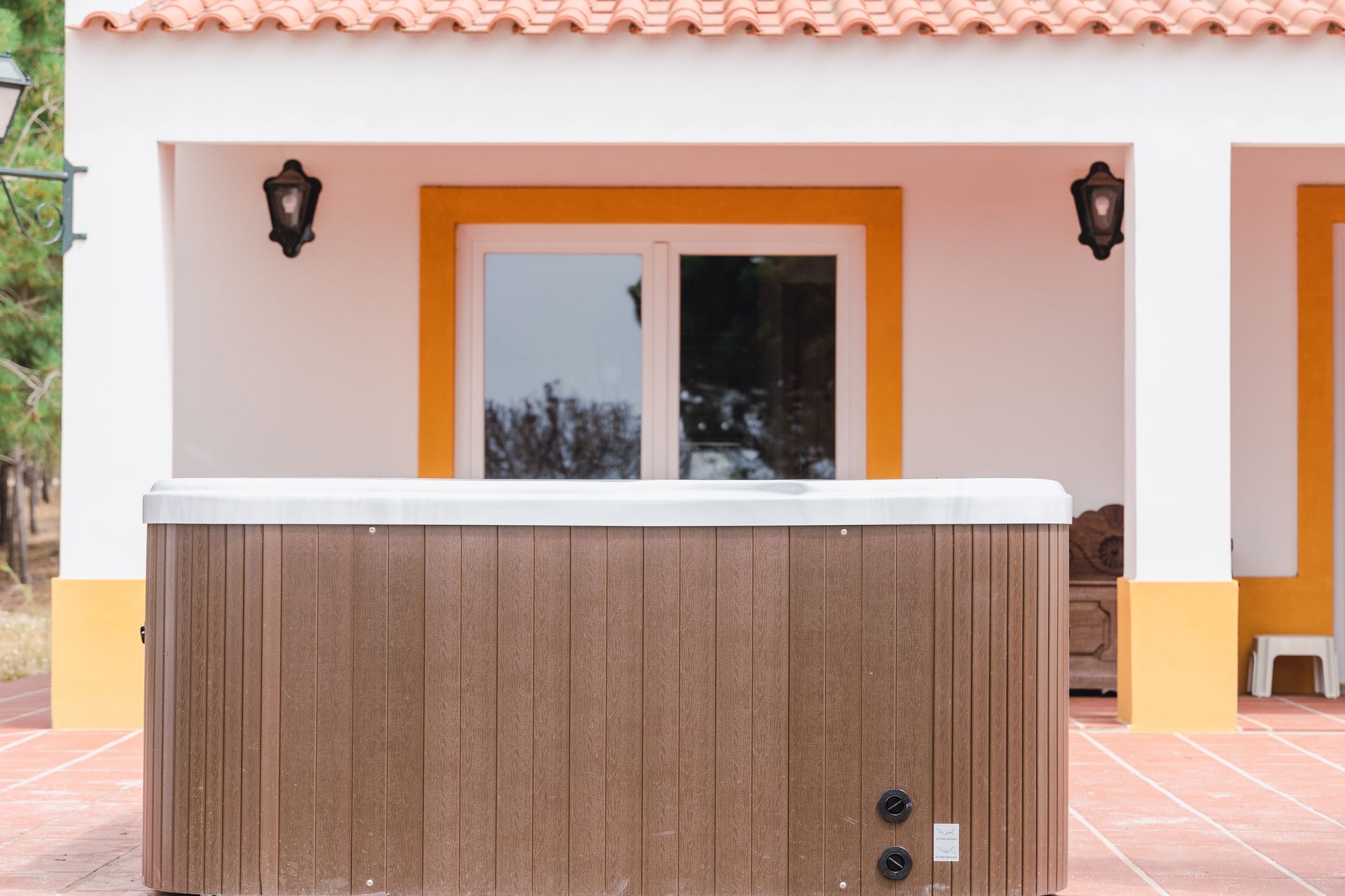 A hot tub is sitting outside of a house.