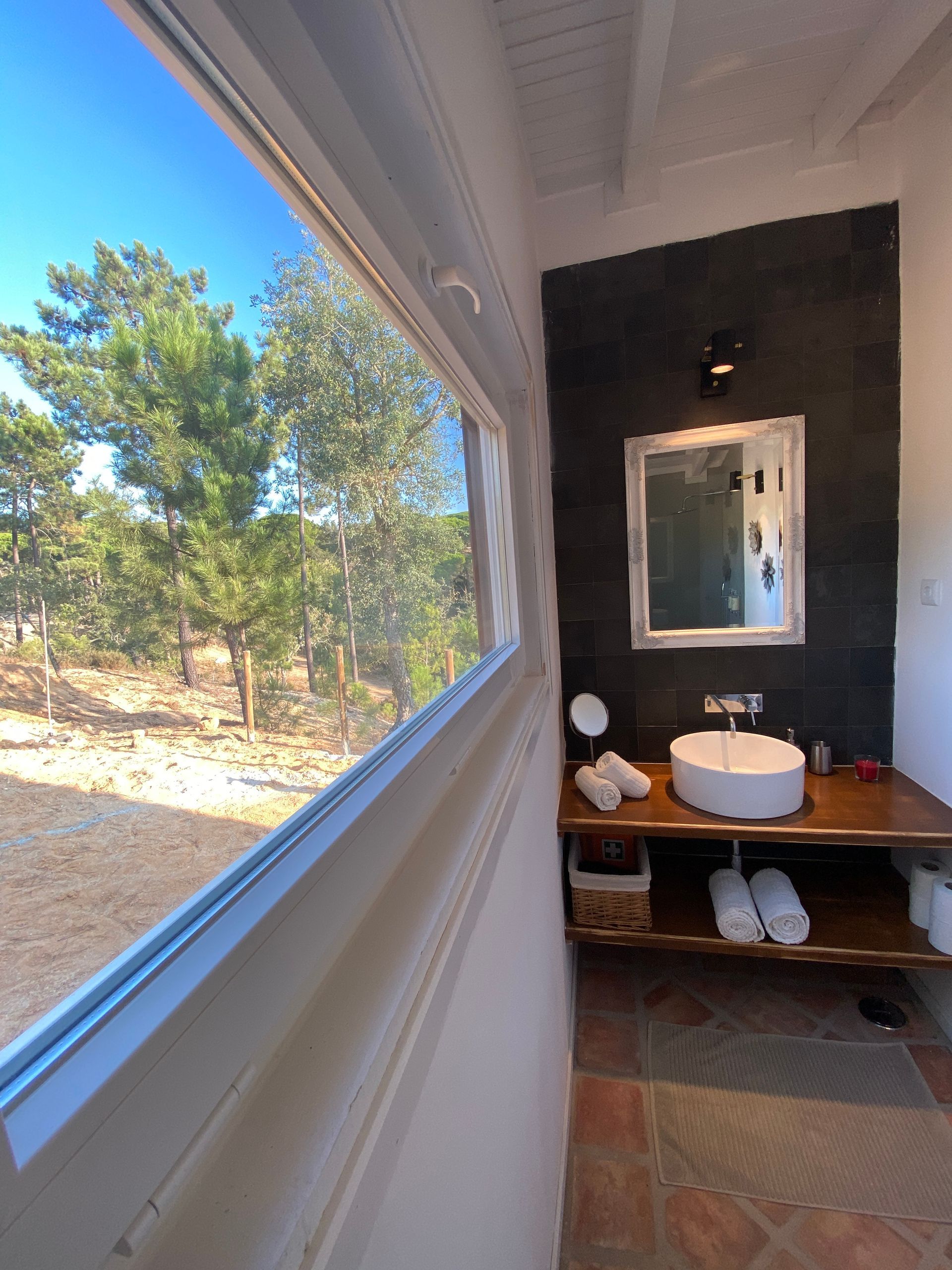 A bathroom with a sink a mirror and a window