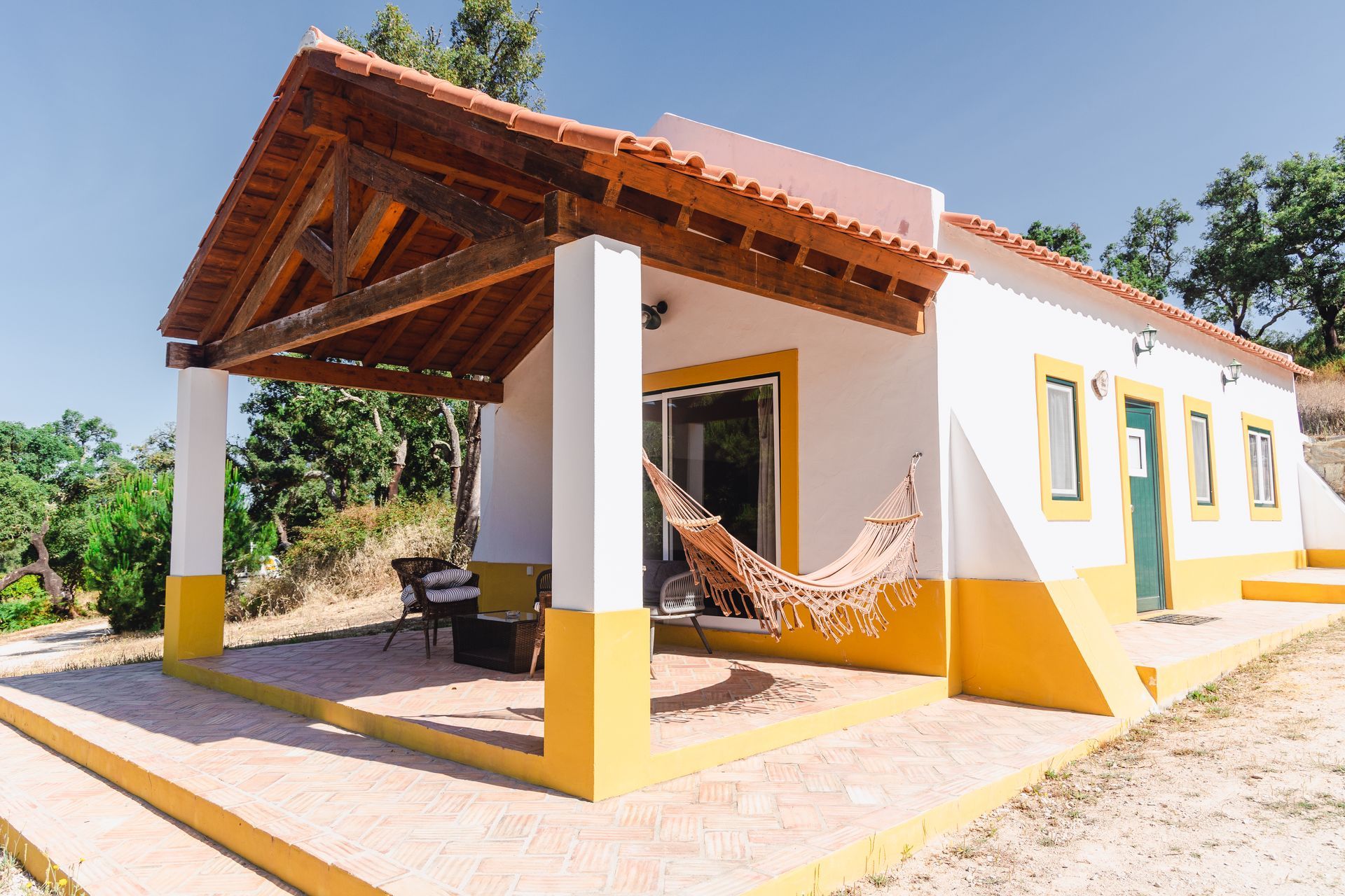A white house with a hammock on the porch