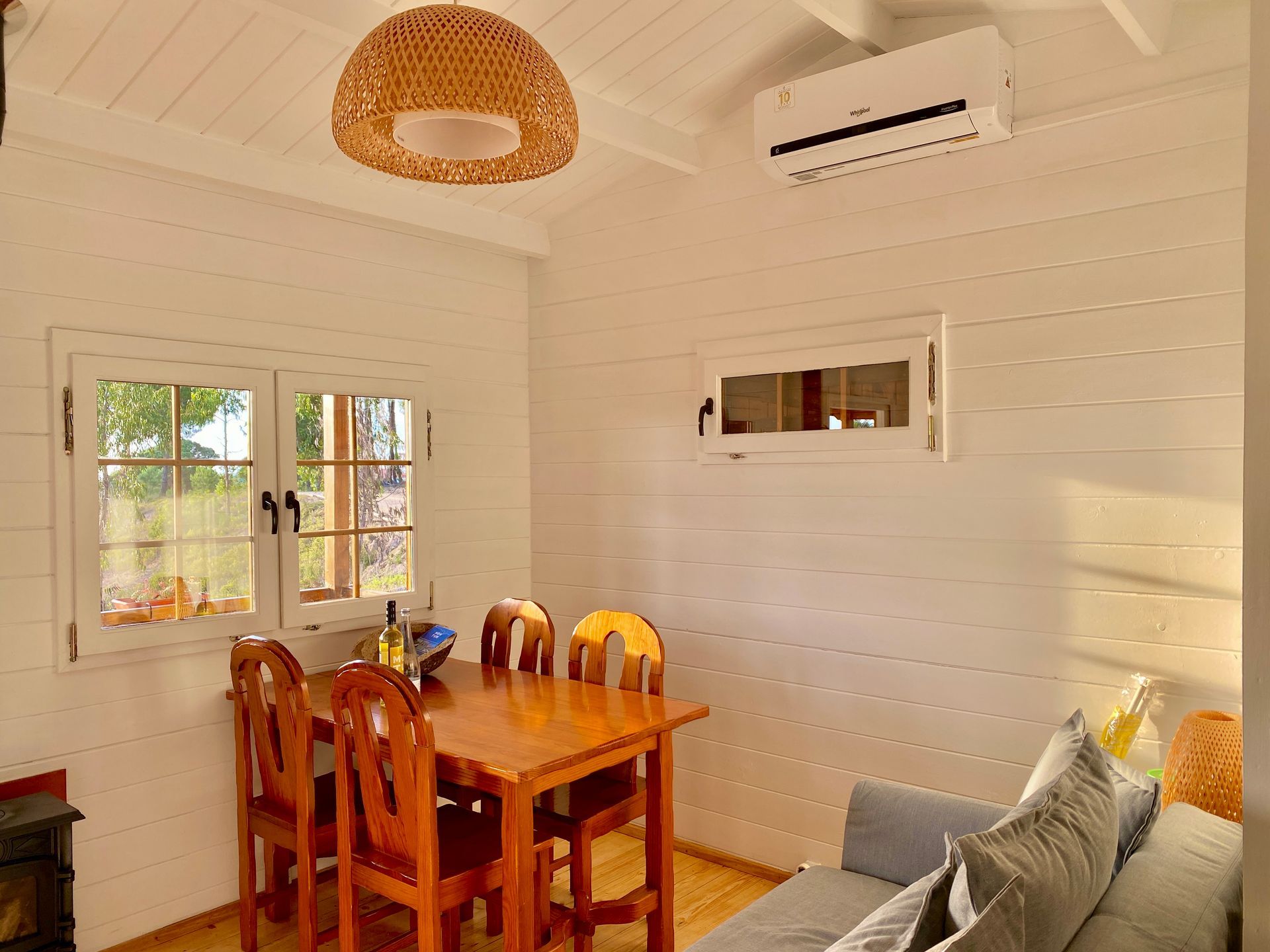 A living room with a table and chairs and a couch.