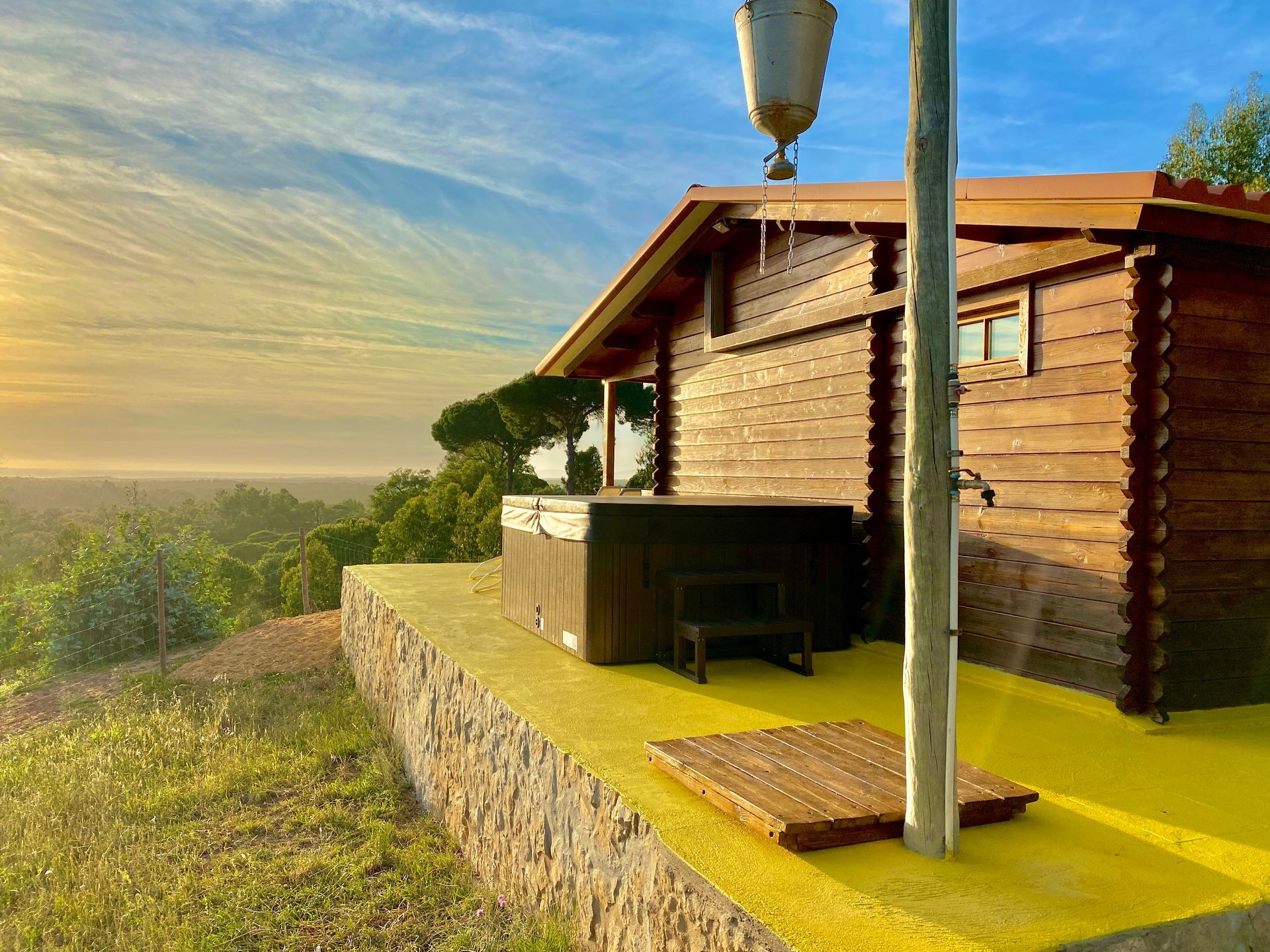 A wooden house with a hot tub in front of it.