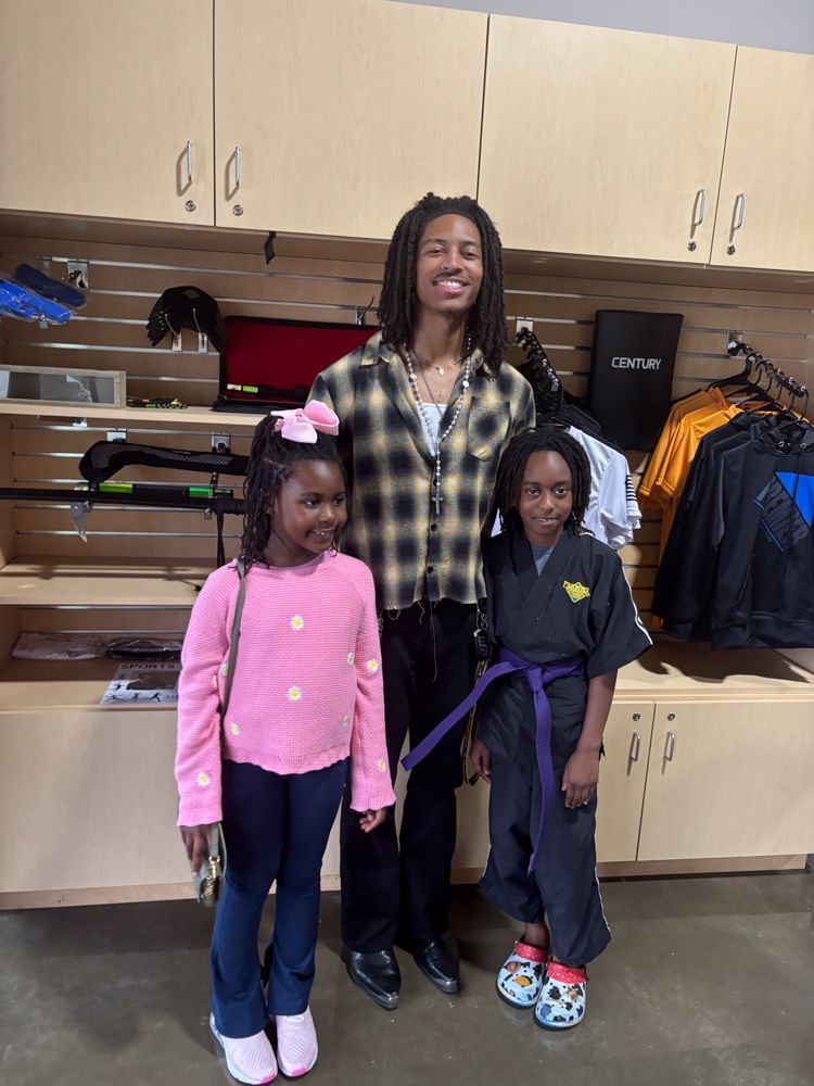 A man and two children are posing for a picture in a store.