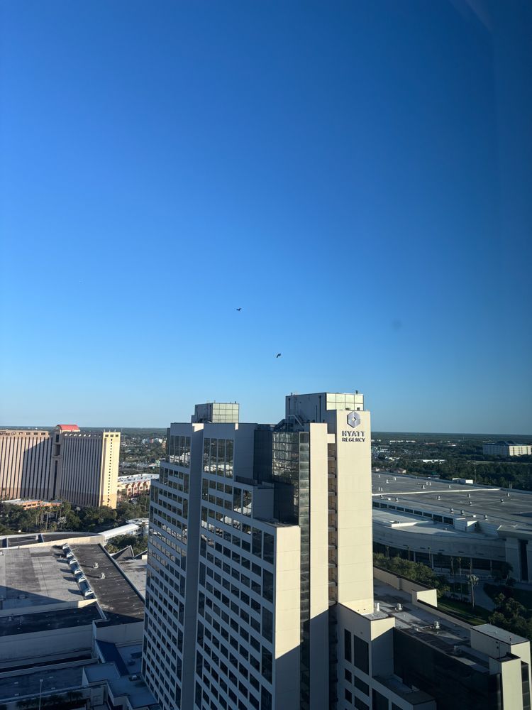 An aerial view of a city with a large building in the foreground.