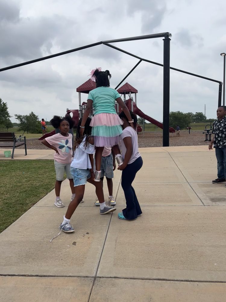 A group of young girls are playing in a park