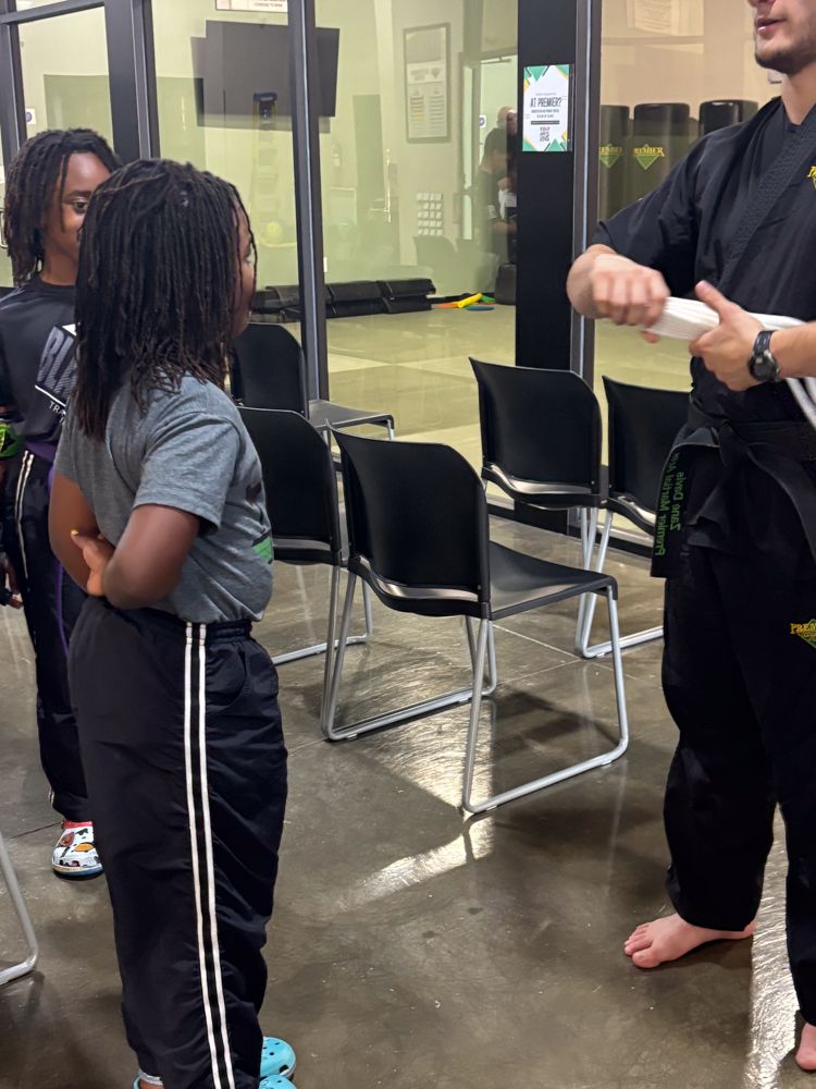 A group of people are standing in a room talking to each other
