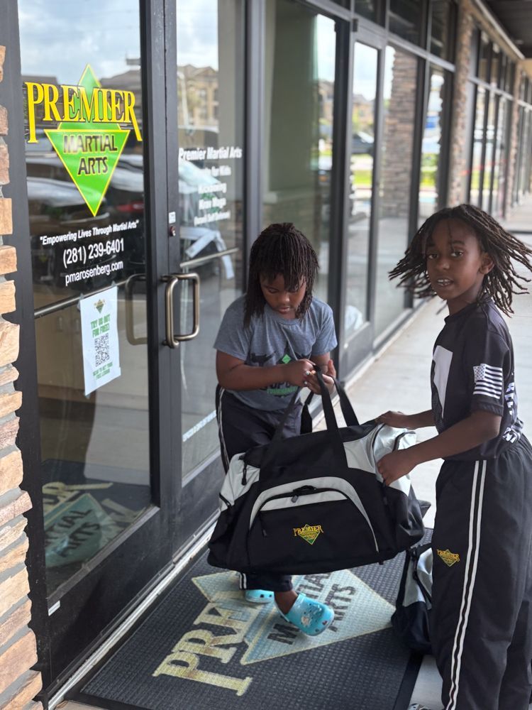 Two children are standing in front of a premier auto store