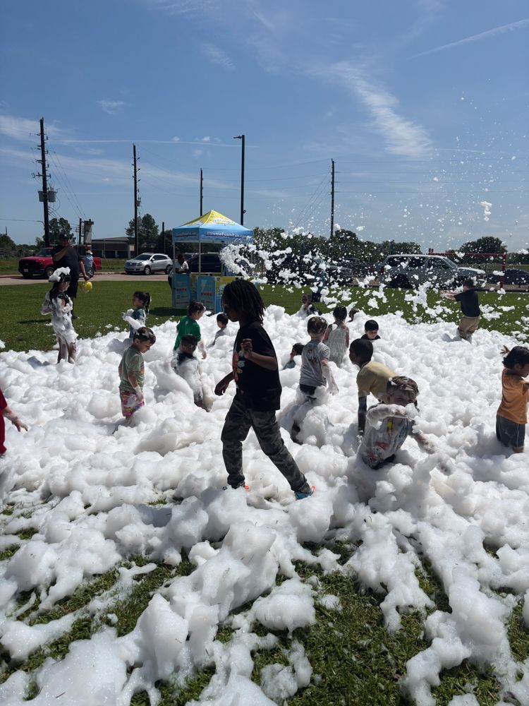 A group of children are playing in a field of foam