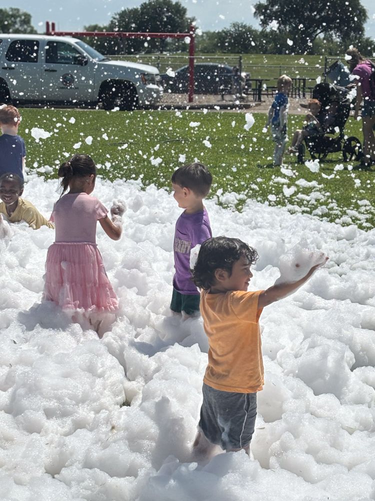 A group of children are playing in a pile of foam.