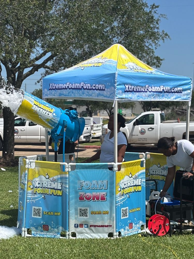 A man is standing in front of a tent with foam coming out of it.