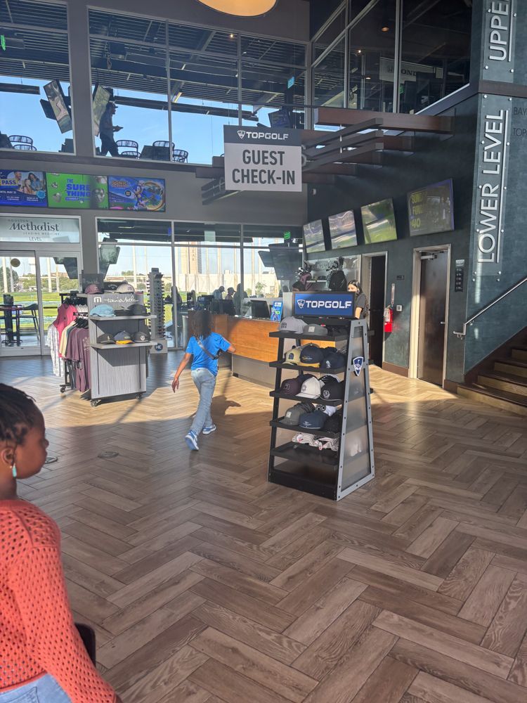 A woman is standing in a room with a sign that says guest check in