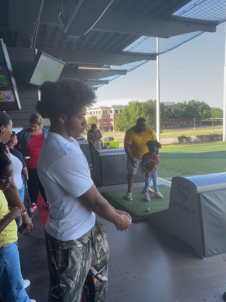 A group of people are playing golf at a golf course.