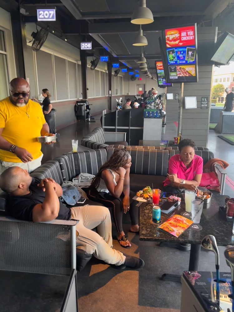 A group of people are sitting on a couch in a restaurant.