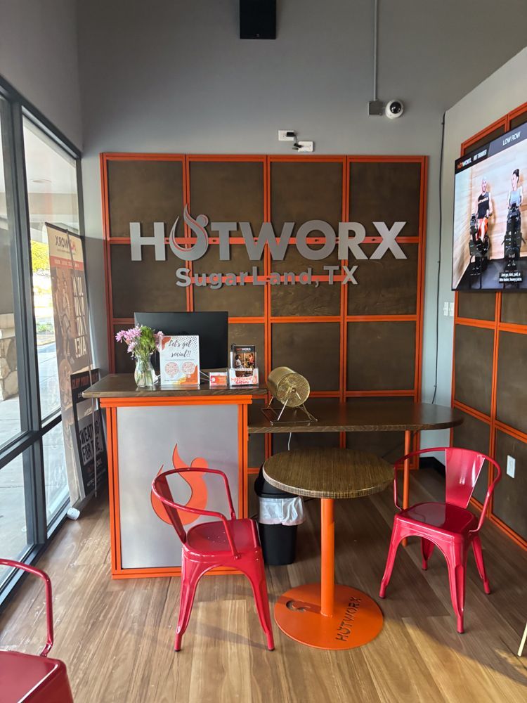 A restaurant with a table and chairs in front of a sign that says hotwork.