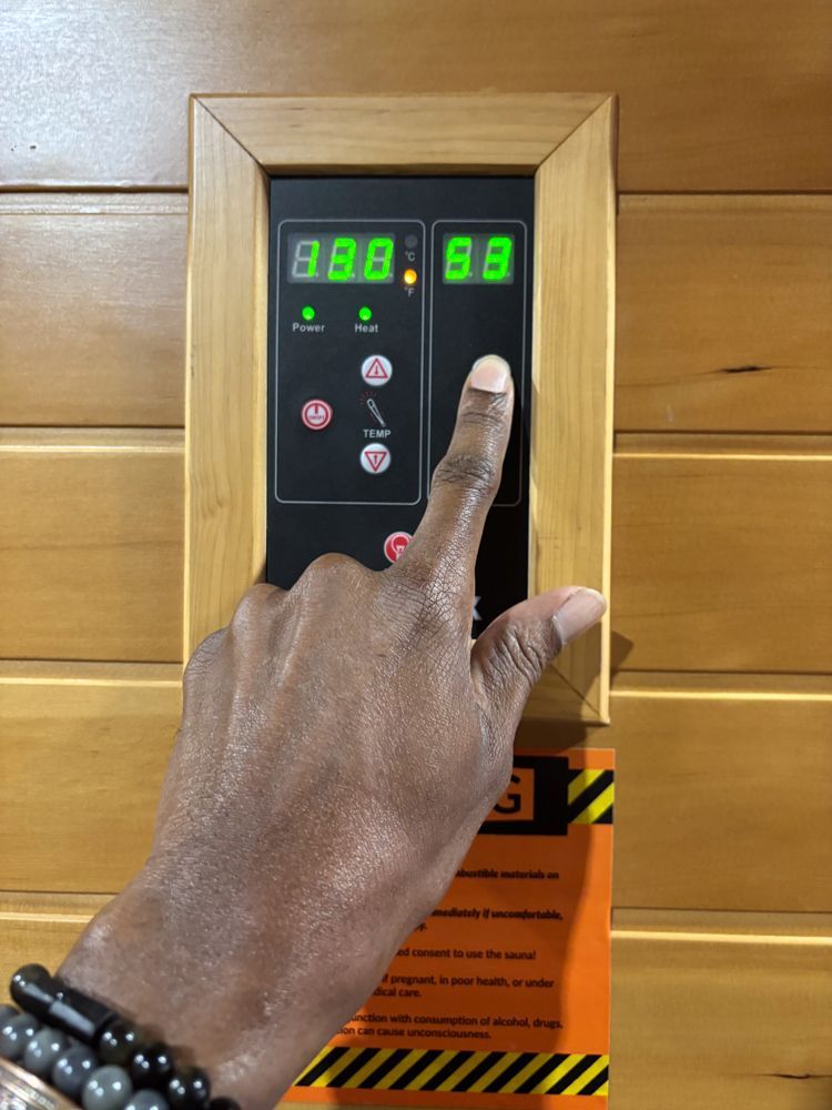 A person is pressing a button on a control panel