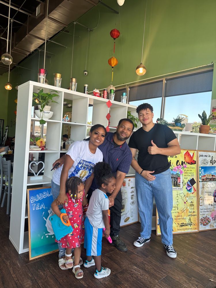 A group of people are posing for a picture in a restaurant.