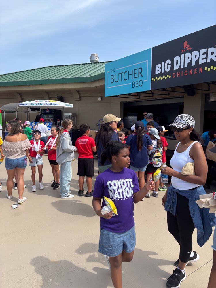 A group of people are standing in front of a big dipper chicken restaurant.