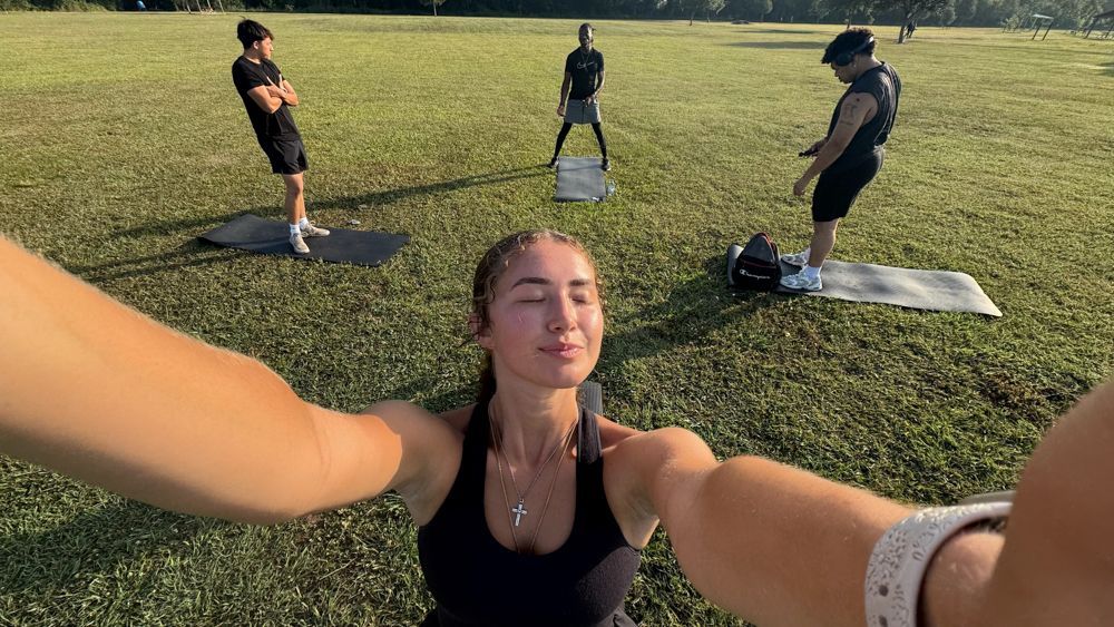 A group of people are doing yoga in a park.