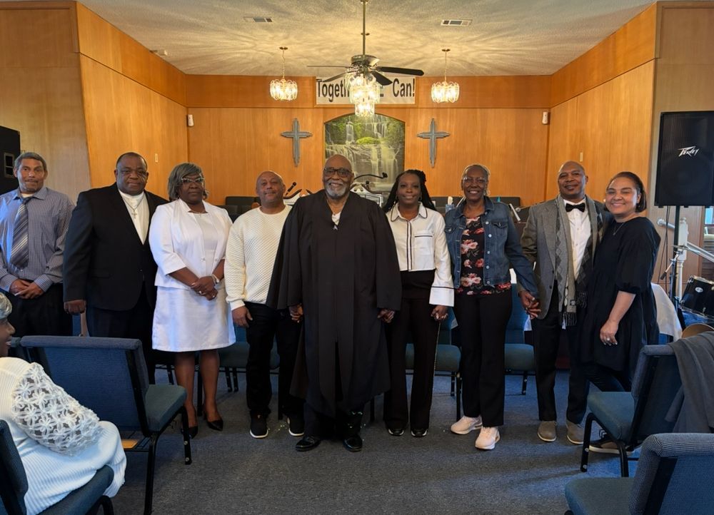 A group of people are posing for a picture in a church.