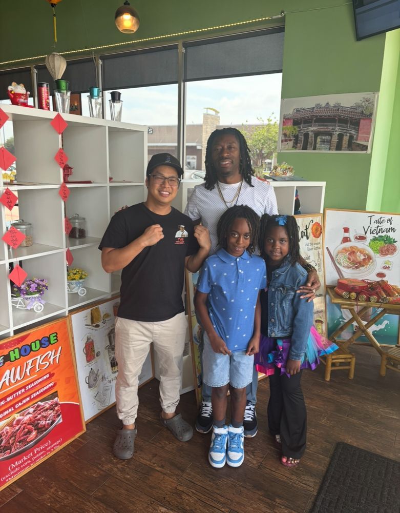 A group of people are posing for a picture in a restaurant.
