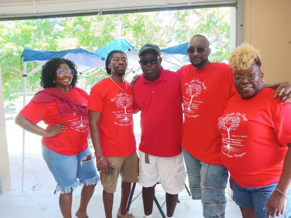 A group of people wearing red shirts are posing for a picture.