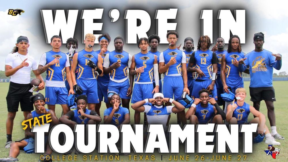 A group of young men are posing for a picture in front of a sign that says we 're in tournament.