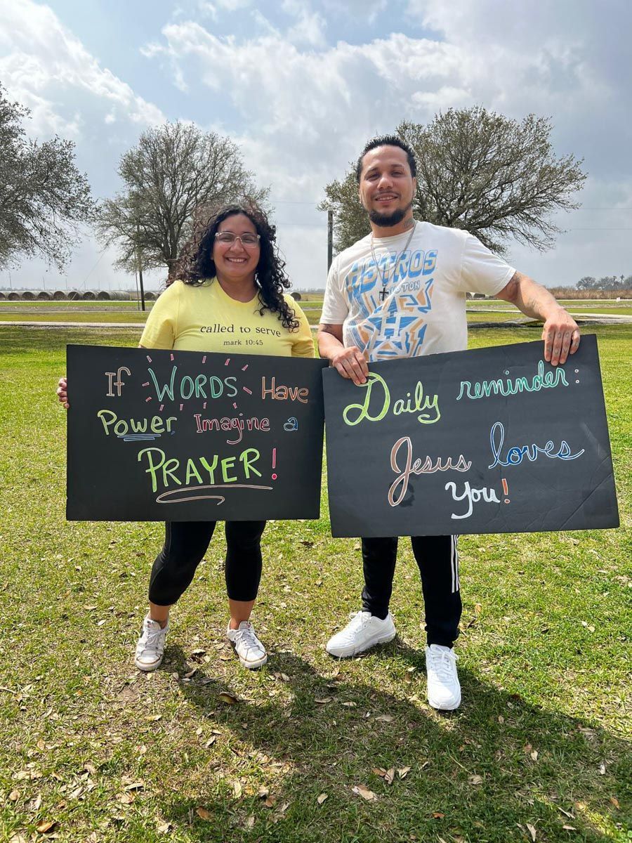 A man and a woman are holding signs that say if words have power bring me a prayer daily reminder jesus loves you