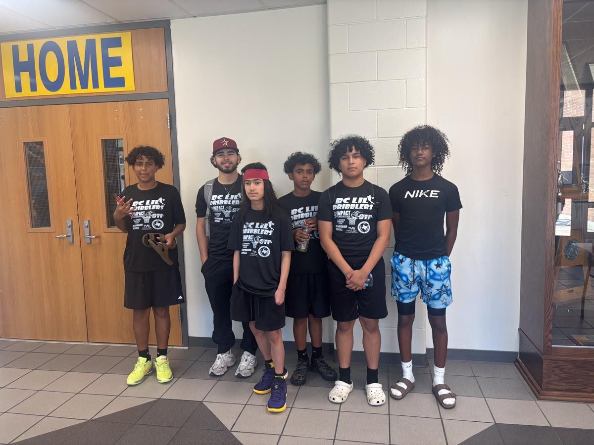 A group of young people standing in front of a door that says home