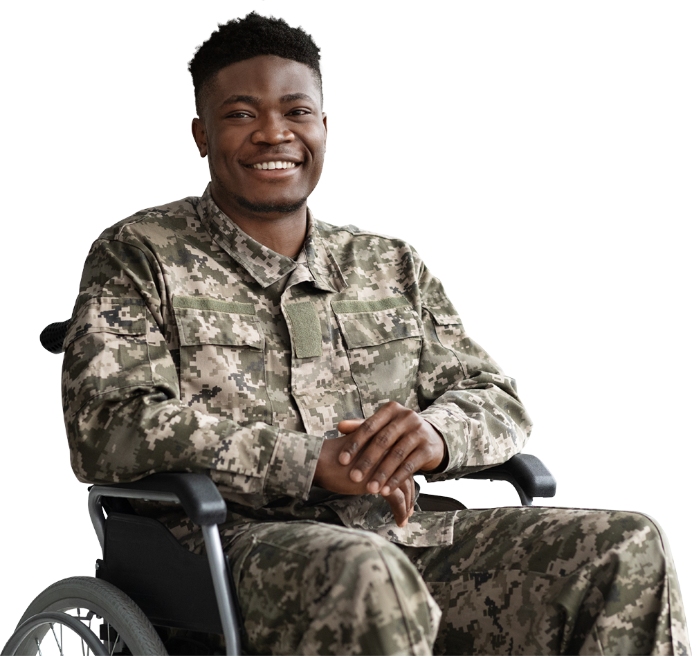A soldier is sitting in a wheelchair and smiling.