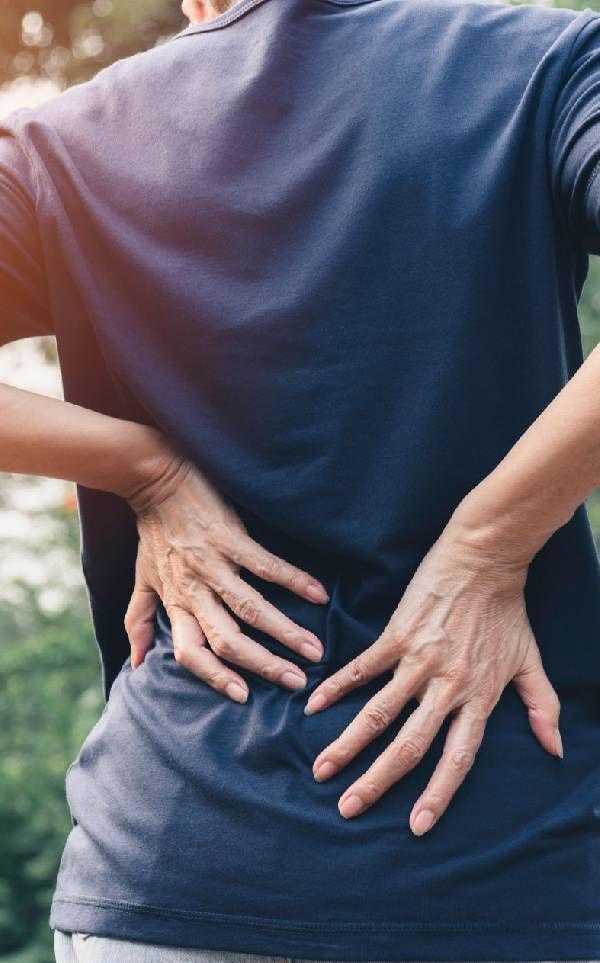 Hands of Woman Touching Her Back Pain