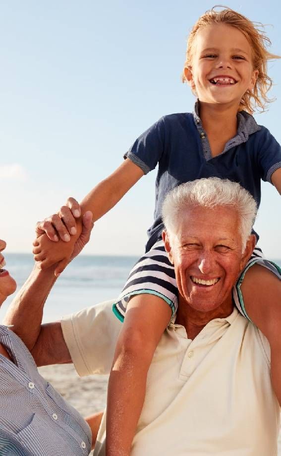 Grandparents Carrying Grandson on Shoulders