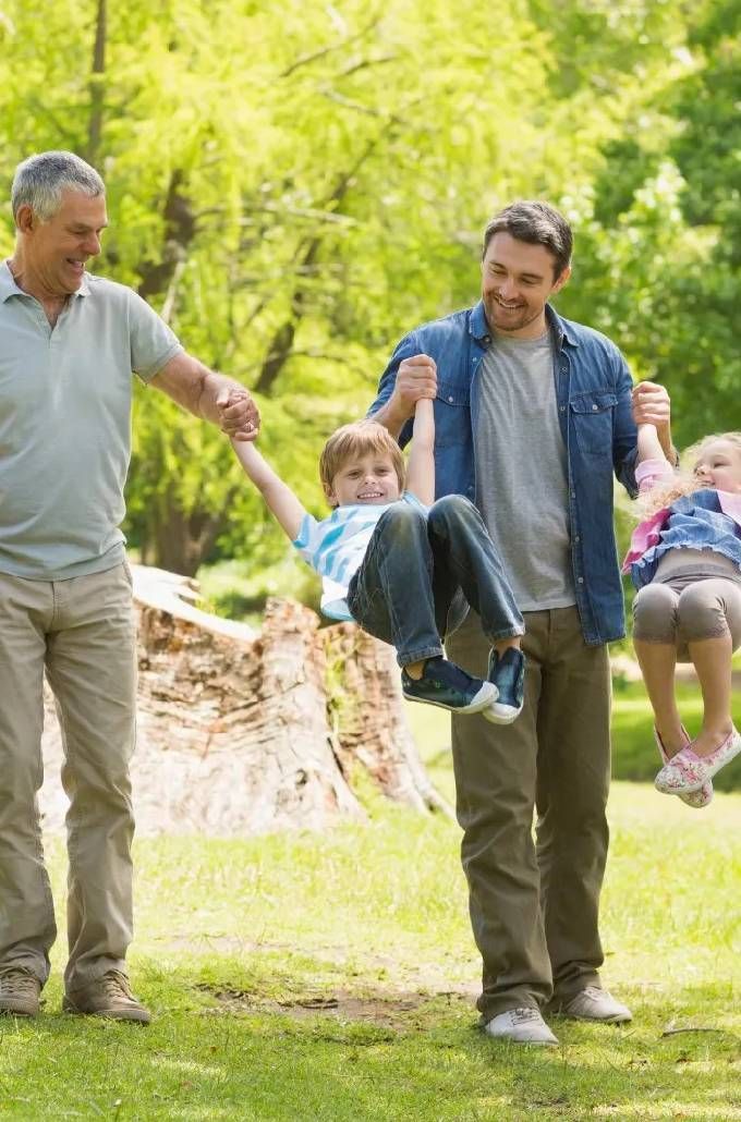 Full Length of An Extended Family Playing in The Park