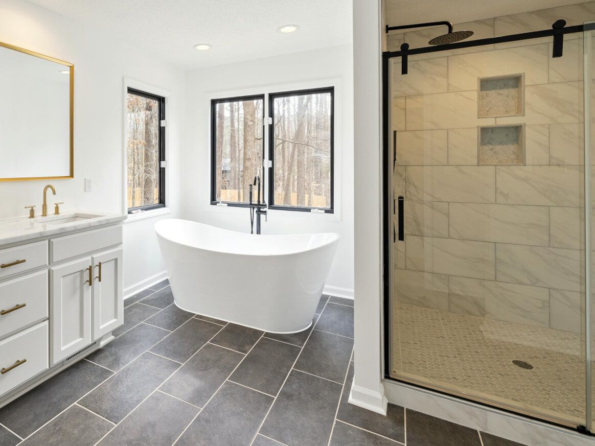 Large open plan Swansea bathroom - floor and shower wall tiled by Daffodil Tiling.