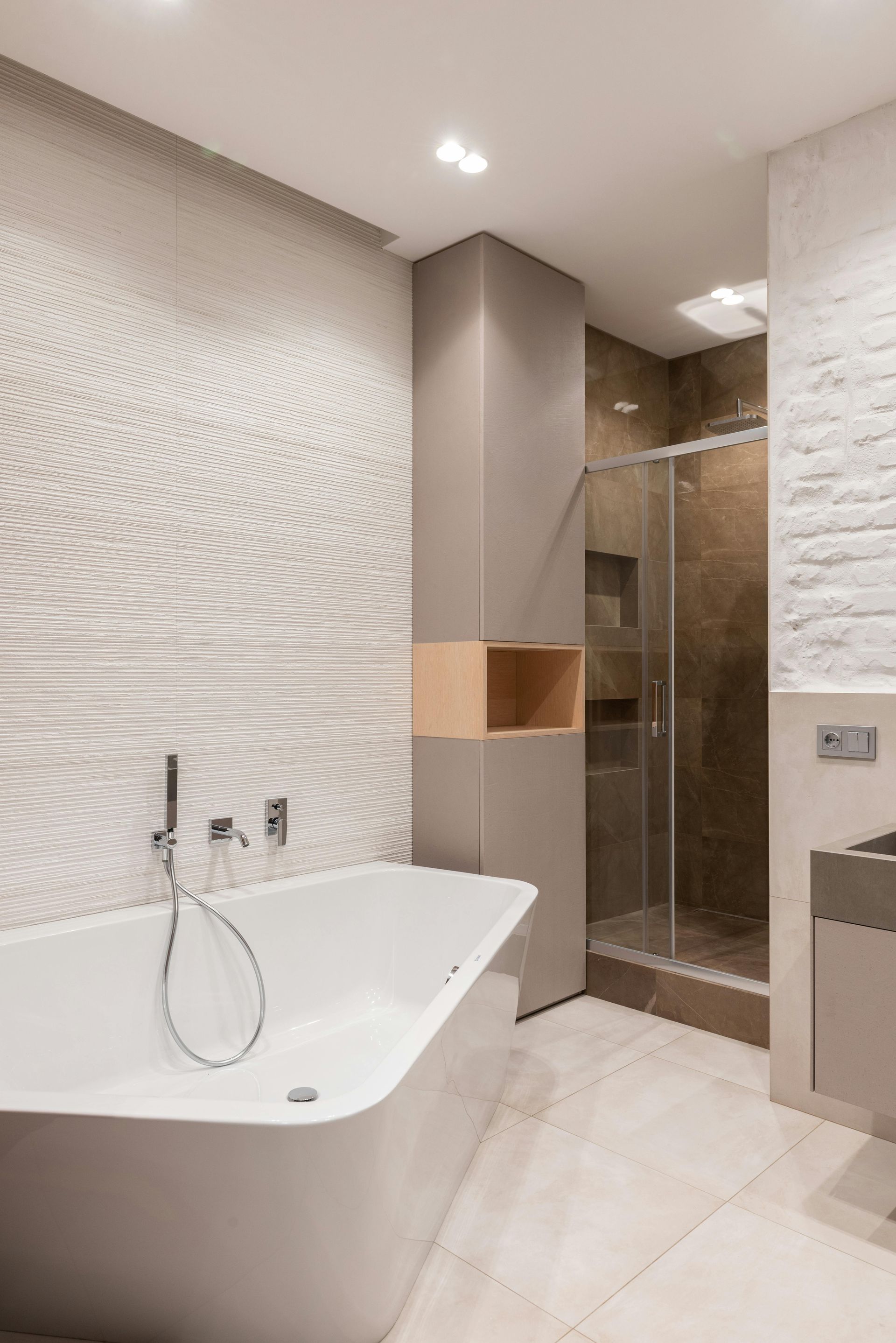 A lovely bathroom tiled in soft earthy tones
