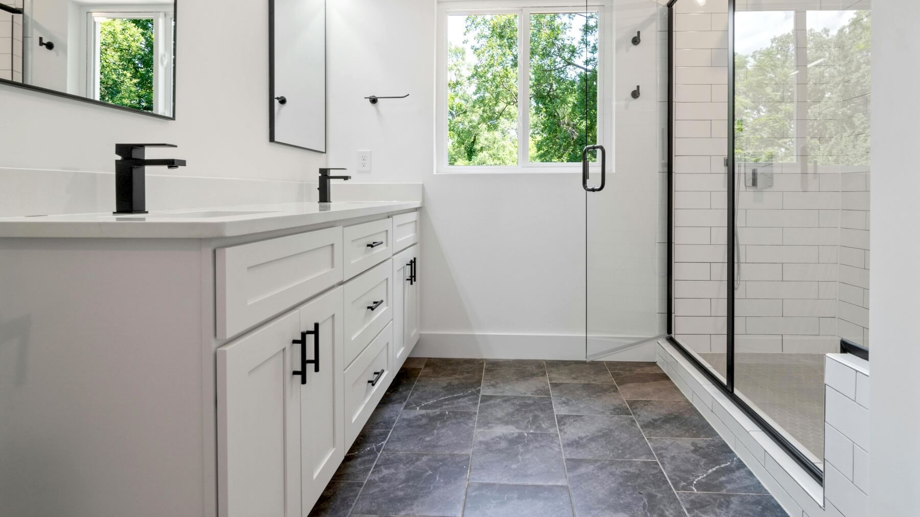 Swansea bathroom with floor and shower tiled in grey and white by Daffodil Tiling.