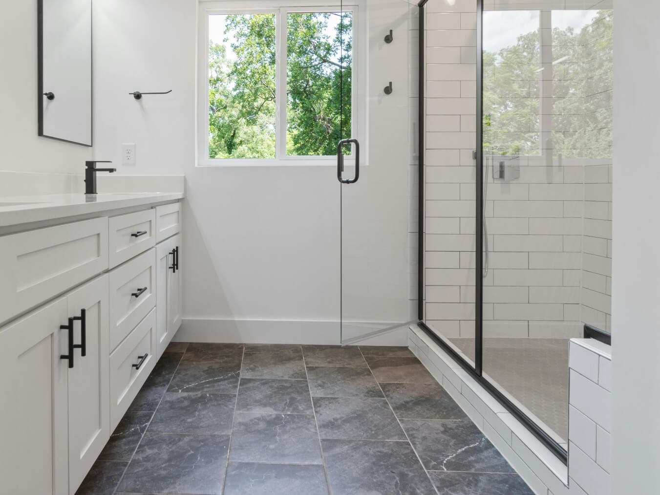 Swansea bathroom with floor and shower tiled in grey and white by Daffodil Tiling.