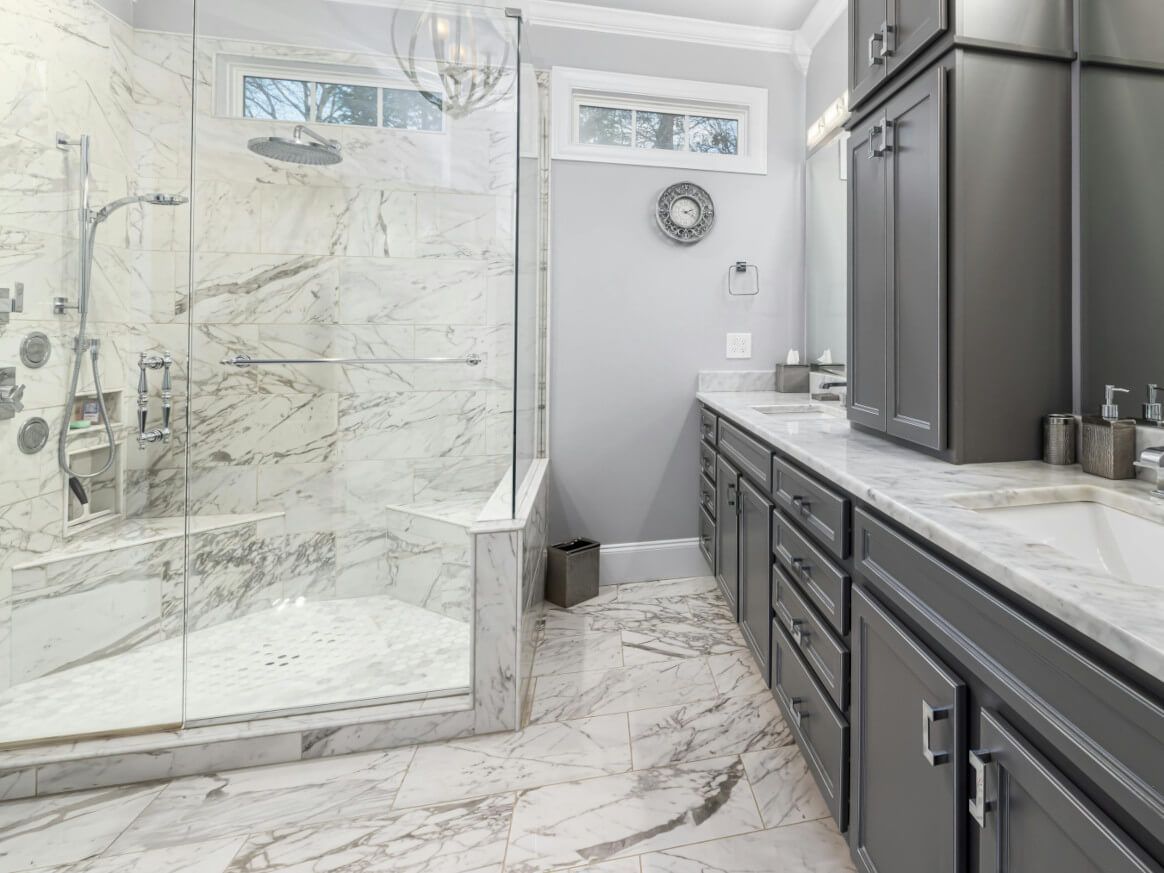 Swansea bathroom with luxury marble floor and shower and wall tiling by Daffodil Tiling.