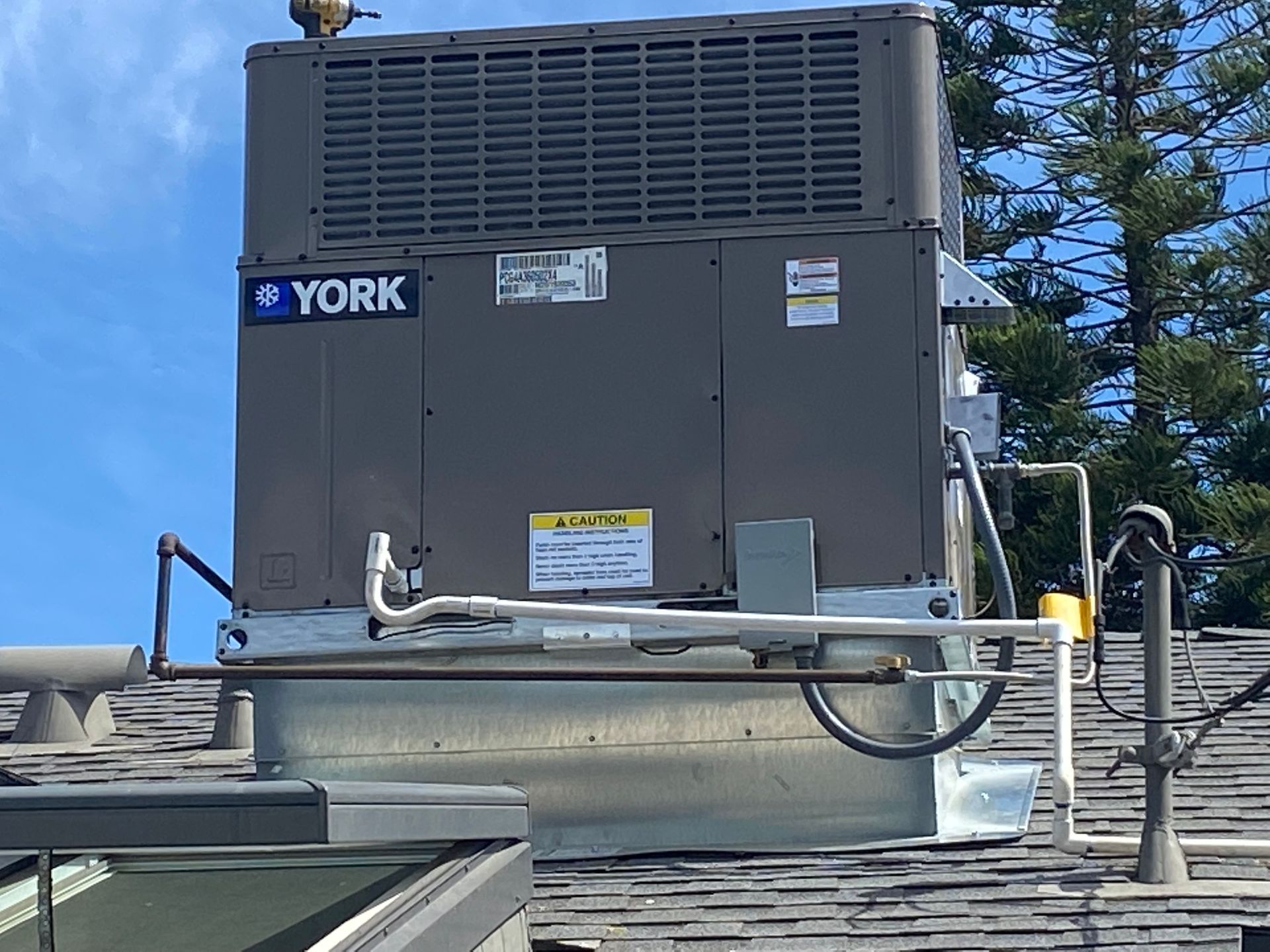 A york air conditioner is sitting on top of a roof.