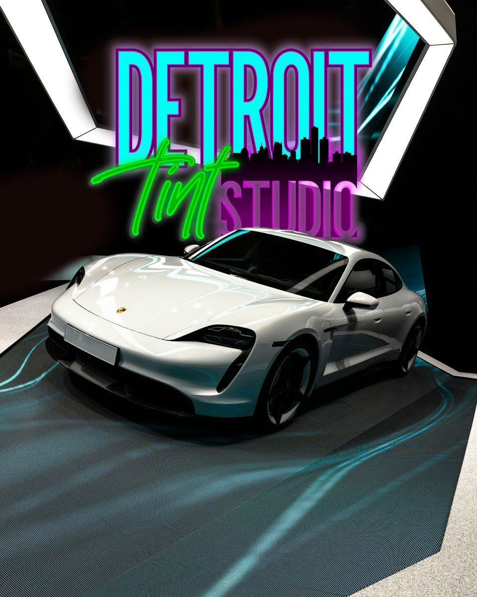 a gray car is parked in a garage on a tiled floor .