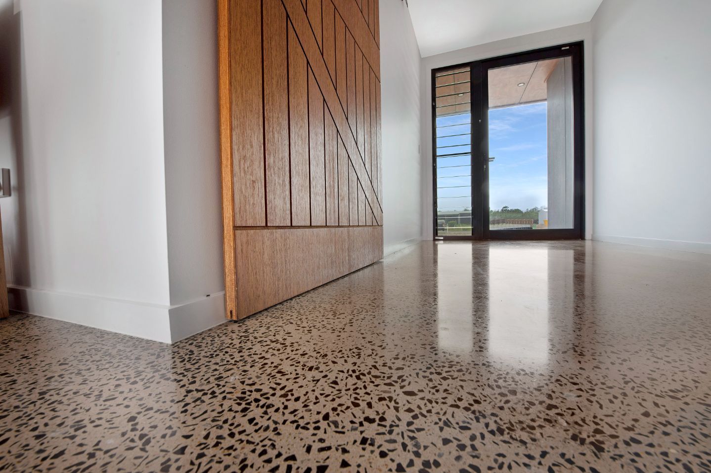 Polished Concrete Floor With Black Specks In Hallway — Concrete Grind & Seal in Bundaberg South, QLD