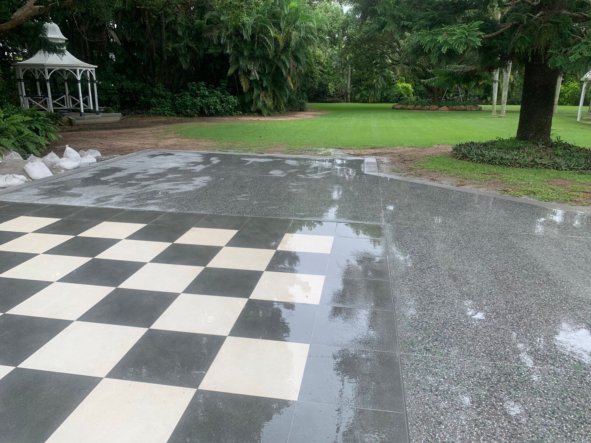 A black and white checkered floor with a gazebo in the background   — Showcase Concrete & Polishing in Bundaberg South, QLD